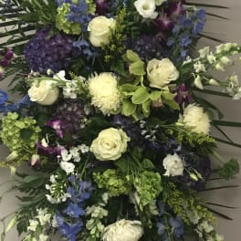 Large standing spray with white roses, blue flowers, and purple orchids