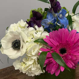 Bouquet with white hydrangeas, pink and white gerbera daisies, and blue and purple flowers