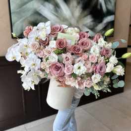 Large bouquet of pink roses and white orchids in a white box
