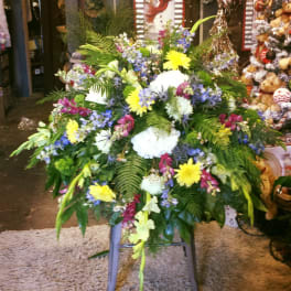 Large mixed floral spray with yellow, white, blue, and pink blooms