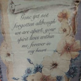 Decorative memorial plaque with flowers and a remembrance quote