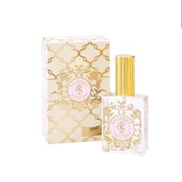 Perfume bottle with gold cap beside a matching patterned box