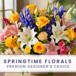 Colorful bouquet of roses, lilies, and iris with a springtime floral sign