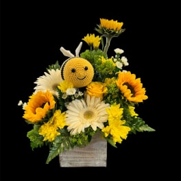 Sunflower and daisy arrangement with a crocheted bee in a wooden box