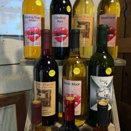 Assorted wine bottles displayed on wooden shelves