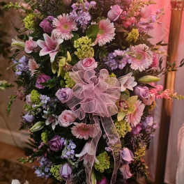 Large pink and lavender floral spray with a sheer ribbon bow