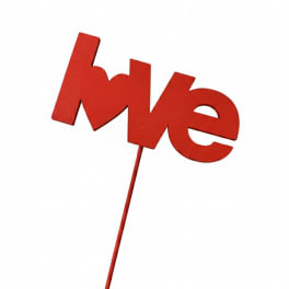 Red "love" sign on a stick against a white background