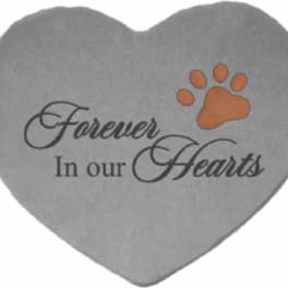 Gray heart-shaped memorial stone with "Forever In our Hearts" text and a paw print