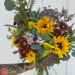 Hand-tied bouquet of yellow sunflowers and burgundy chrysanthemums
