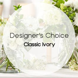 White floral arrangement with roses and daisies in glass vases