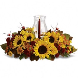 Sunflower and autumn flower centerpiece with a glass candle holder