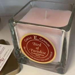 Square glass candle with a pale pink wax fill and label