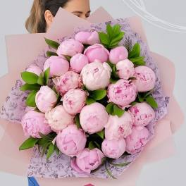 Large bouquet of pink peonies wrapped in pale pink paper