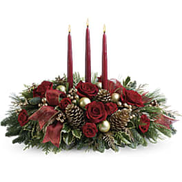 Holiday centerpiece with red roses and three burgundy candles