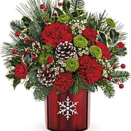 Christmas bouquet in a red vase with pinecones and red flowers