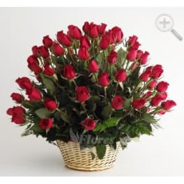 Basket of red roses arranged in a rounded bouquet