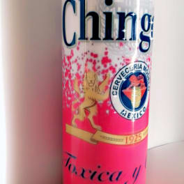 Pink and white candle in a glass jar with printed label