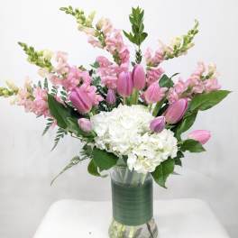 Pink tulips and white hydrangeas in a glass vase
