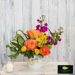Colorful flower arrangement in a white mug with "Birthday Queen" text