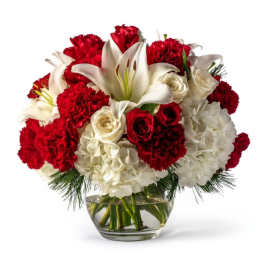 Red and white flower arrangement in a glass vase