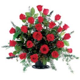 Red roses arranged in a black vase with greenery
