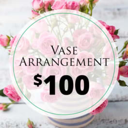 Pink rose arrangement in a striped vase with a price label overlay