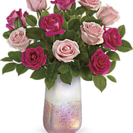 Bouquet of pink and magenta roses in a frosted glass vase