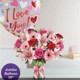 Pink and red flower bouquet with a heart balloon reading I Love You