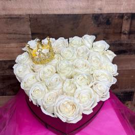 Heart-shaped box of white roses with a gold crown topper