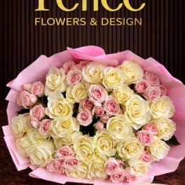 Bouquet of cream and pink roses wrapped in pink paper