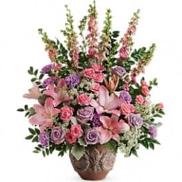 Pink and lavender floral arrangement in a decorative vase