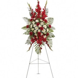 Standing floral spray with red and white flowers on an easel