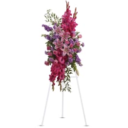 Tall standing floral spray with pink lilies, roses, and purple blooms