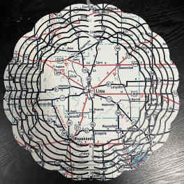 Round map-cutout decorative piece with layered black rings