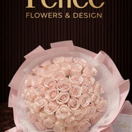 Bouquet of pale pink roses wrapped in pink paper