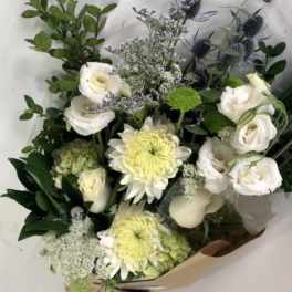 Bouquet of white roses and pale yellow chrysanthemums with greenery