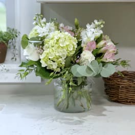 Bouquet of white and pale pink flowers in a glass vase