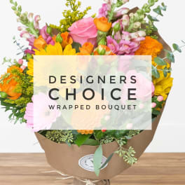Wrapped bouquet of pink, orange, and yellow flowers