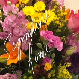 Mixed bouquet with pink roses, purple flowers, and yellow daisies