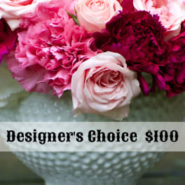 Pink and burgundy roses with carnations in a white vase