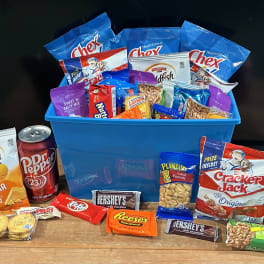 Gift basket with snack bags, candy bars, and soda cans in a blue bin