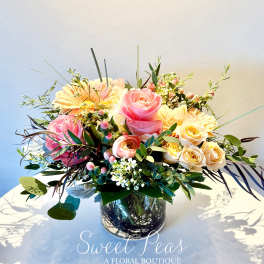 Pink and cream rose bouquet in a glass vase
