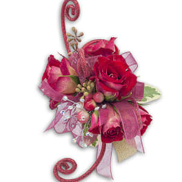 Pink rose arrangement with ribbon and decorative accents
