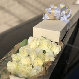 Box of cream roses with a ribbon tied on top