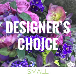 Purple floral arrangement with roses and hellebore blooms
