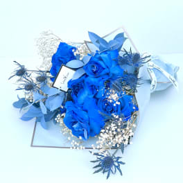 Bouquet of bright blue roses with white baby's breath