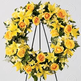 Yellow floral wreath on a black stand