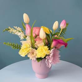 Pink and blush roses with carnations in a white bowl vase