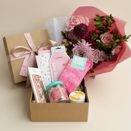 Gift box with pink flowers and assorted self-care items
