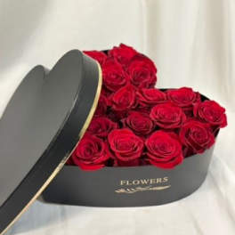 Red roses in a black heart-shaped box